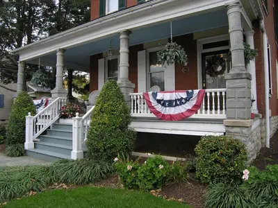 a house with an american flag on the front porch at The Inn & Spa at Intercourse Village in Intercourse