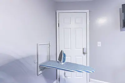 a room with a door and a blue bench at Newark NJ Private Suite NYC Path Train in Newark