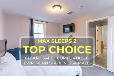 a bedroom with a bed and a top choice sign at Newark NJ Private Suite NYC Path Train in Newark