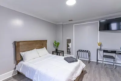 a bedroom with a white bed and a desk at Private BR Trains EWR USA Mall Penn Station in Newark
