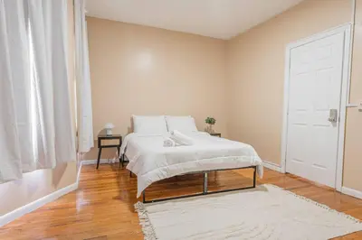 a bedroom with a white bed and a white door at NYC Train EWR Liberty Park 1 in Bayonne