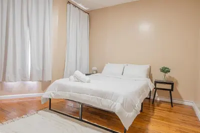 a bedroom with a large bed and a window at NYC Train EWR Liberty Park 1 in Bayonne