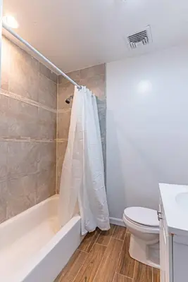 a bathroom with a tub and a toilet and a sink at Private BR Trains EWR USA Mall Penn Station in Newark