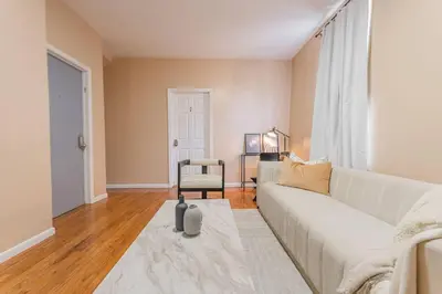 a living room with a couch and a chair at Private BR Wlk to NYC Train 3 in Bayonne