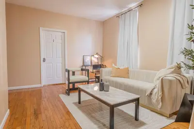 a living room with a couch and a coffee table at Private BR Wlk to NYC Train 3 in Bayonne