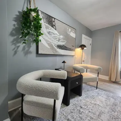 a living room with two chairs and a table at Private Bedroom w Shared Space A in South Hackensack