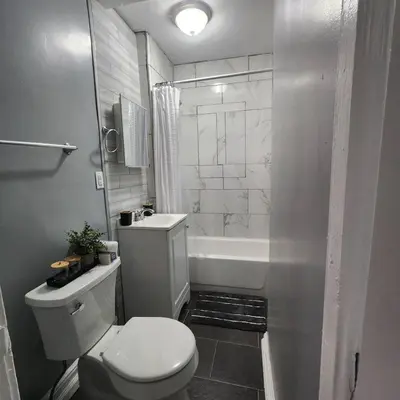 a bathroom with a toilet and a sink and a tub at Private Bedroom In Shared Apt C in South Hackensack