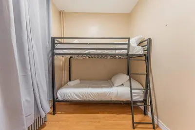 a bunk bed room with two bunk beds in a room at Bunk Room Walk 2 Train Shops in Bayonne