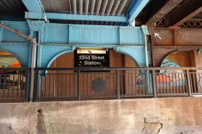 a sign on the side of a bridge at Bunk Room Walk 2 Train Shops in Bayonne