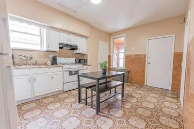 a kitchen with a table in the middle of it at NYC Train EWR Liberty Park 2 in Bayonne