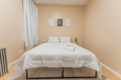 a bedroom with a large white bed in a room at NYC Train EWR Liberty Park 2 in Bayonne