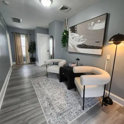 a living room with two chairs and a table at Private Bedroom In Shared Apt B in South Hackensack