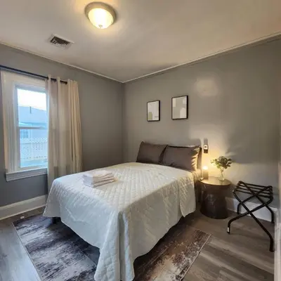 a bedroom with a white bed and a window at Bus Train 2 NYC Spacious 4BR SH in South Hackensack