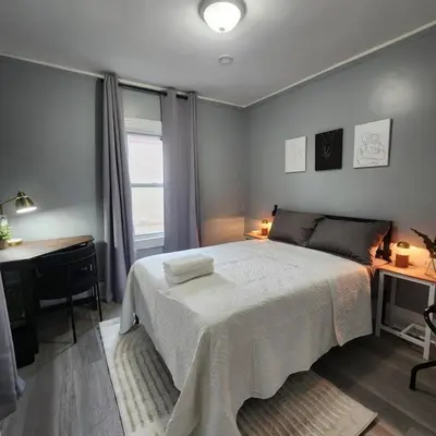 a bedroom with a bed and a desk and a window at Bus Train 2 NYC Spacious 4BR SH in South Hackensack