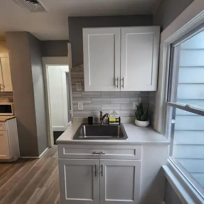 a kitchen with white cabinets and a sink at Bus Train 2 NYC Spacious 4BR SH in South Hackensack