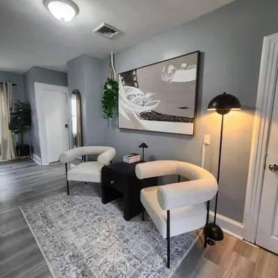 a living room with two chairs and a table at Bus Train 2 NYC Spacious 4BR SH in South Hackensack