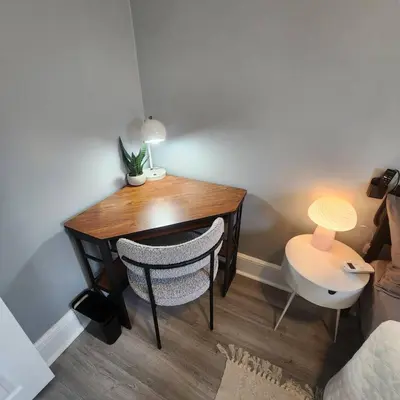 a dining room table with a lamp and a chair at Bus Train 2 NYC Spacious 4BR SH in South Hackensack