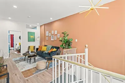 a living room with a couch and a ceiling fan at Stylish 1BR 1,5BA Old City Condo Near Liberty Bell in Philadelphia