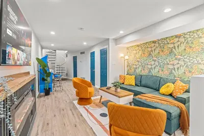 a living room with a green couch and a painting on the wall at Stylish 1BR 1,5BA Old City Condo Near Liberty Bell in Philadelphia