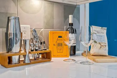 a counter with wine glasses and a bottle of wine at Stylish 1BR 1,5BA Old City Condo Near Liberty Bell in Philadelphia