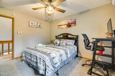 a bedroom with a bed and a desk and a ceiling fan at Home with Fire Pit in Jim Thorpe 6 Mi to Dtwn! in Jim Thorpe