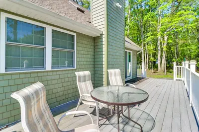 a patio with a table and chairs on a deck at Home with Fire Pit in Jim Thorpe 6 Mi to Dtwn! in Jim Thorpe