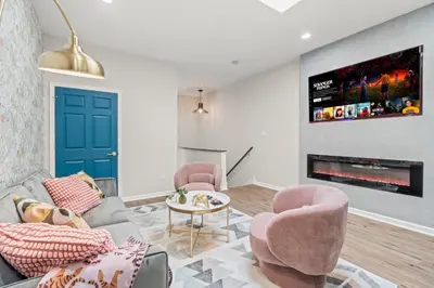 a living room with a couch and chairs and a tv at Historic Old City 1BR 1BA Near Independence Hall in Philadelphia