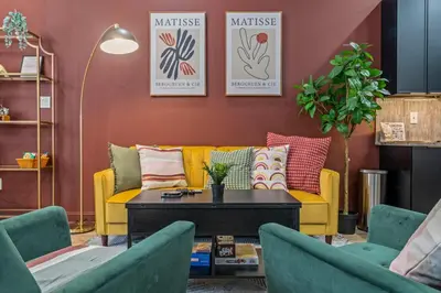 a living room with a yellow couch and two chairs at Old City History Kid-Friendly 2BR 1,5BA in Philadelphia
