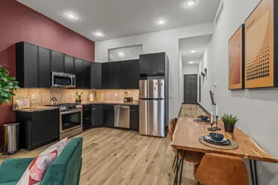 a kitchen with a wooden table and a dining room at Old City History Kid-Friendly 2BR 1,5BA in Philadelphia