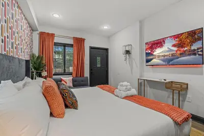 a bedroom with a large white bed with orange pillows at Old City History Kid-Friendly 2BR 1,5BA in Philadelphia