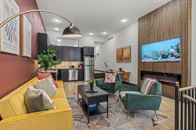 a living room with a yellow couch and green chairs at Old City History Kid-Friendly 2BR 1,5BA in Philadelphia