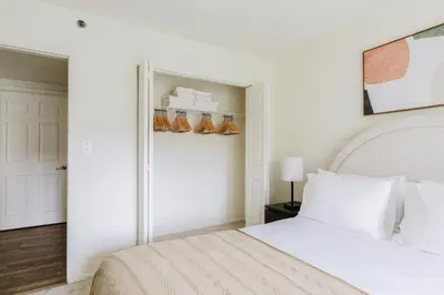 a bedroom with a white bed and a closet at Blueground Hudson Exchange pool nr Liberty Park NYC-1800 in New York