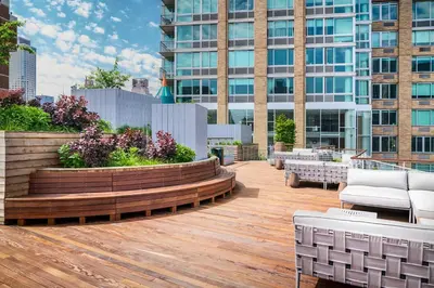 a rooftop deck with benches and tables on a building at Blueground Lincoln Square rooftop nr Central Park NYC-1217 in New York
