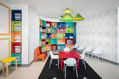 a classroom with a table and chairs and bookshelves at Blueground Lincoln Square rooftop nr Central Park NYC-1217 in New York