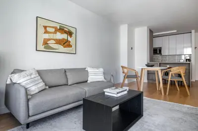 a living room with a couch and a table at Blueground Lincoln Square rooftop nr Central Park NYC-1217 in New York