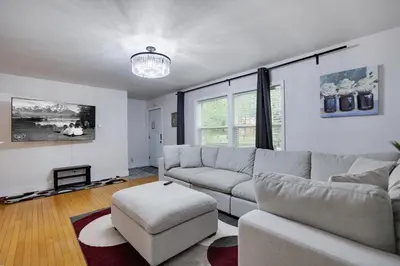 a living room with a couch and a chair at Hot Tub & Theater Haven-Lake and Ski Retreat in Blakeslee