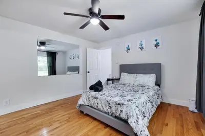a bedroom with a bed and a ceiling fan at Hot Tub & Theater Haven-Lake and Ski Retreat in Blakeslee