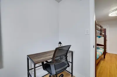 a desk and a chair in a room with a bedroom at Hot Tub & Theater Haven-Lake and Ski Retreat in Blakeslee