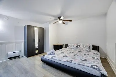 a bedroom with a bed and a ceiling fan at Hot Tub & Theater Haven-Lake and Ski Retreat in Blakeslee