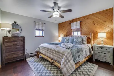 a bedroom with a bed and a ceiling fan at Moose Tracks Cabin Hot Tub 5 Min to Slopes in Lake Harmony