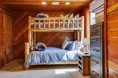 a bedroom with a bunk bed in a cabin at Moose Tracks Cabin Hot Tub 5 Min to Slopes in Lake Harmony