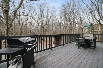 a grill and a picnic table on a deck at Moose Tracks Cabin Hot Tub 5 Min to Slopes in Lake Harmony