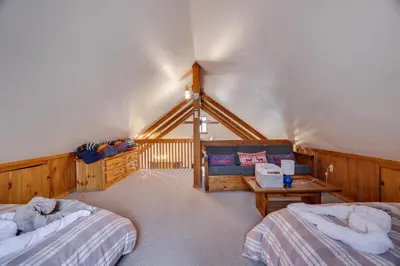 a bedroom with two beds and a couch at Moose Tracks Cabin Hot Tub 5 Min to Slopes in Lake Harmony