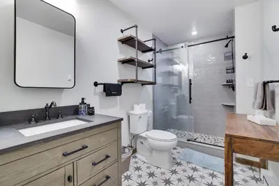 a bathroom with a toilet and a sink and a shower at Moose Tracks Cabin Hot Tub 5 Min to Slopes in Lake Harmony