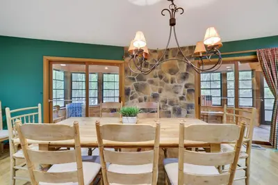 a dining room with a wooden table and chairs at Arrowhead Lodge Walk to Lake & Private Dock in Pocono Lake