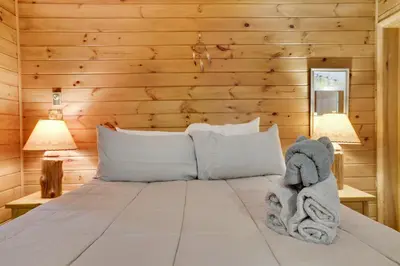 a bedroom with a bed with a stuffed elephant on it at Arrowhead Lodge Walk to Lake & Private Dock in Pocono Lake
