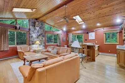 a living room with a couch and a table at Arrowhead Lodge Walk to Lake & Private Dock in Pocono Lake