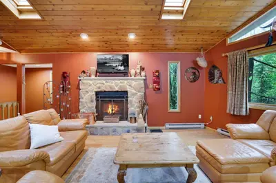 a living room with a couch and a fireplace at Arrowhead Lodge Walk to Lake & Private Dock in Pocono Lake