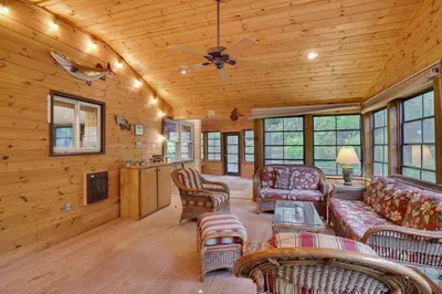 a living room with furniture and a ceiling fan at Arrowhead Lodge Walk to Lake & Private Dock in Pocono Lake