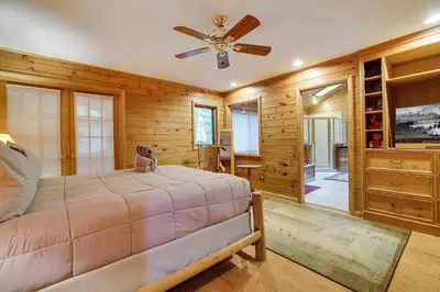a bedroom with a bed and a ceiling fan at Arrowhead Lodge Walk to Lake & Private Dock in Pocono Lake